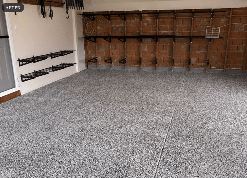 The completed flake floor with the rear wall stripped back to bare brick and grey waterproofing material installed at the base of the wall.